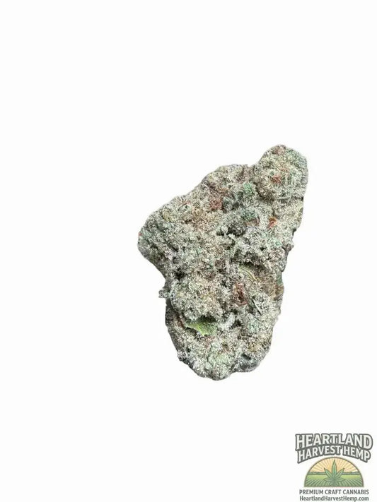 Dried cannabis flower bud with trichomes and green hues on white background